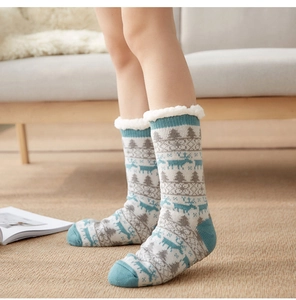 Close-up of thick fleece-lined knit socks with reindeer patterns for winter warmth