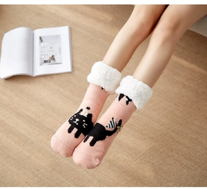 Detail of pink fleece-lined slipper socks with white faux fur cuff and cat pattern