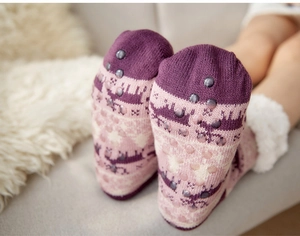Detail of anti-slip rubber dots on plush sherpa-lined thick winter home slipper socks