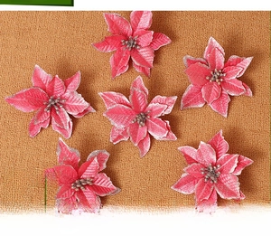 Close-up of 6 pink artificial poinsettia flowers with silver glitter edges for decor