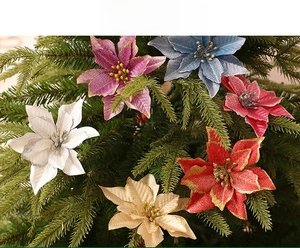Close-up of glitter-edged artificial poinsettias in various colors on a Christmas tree