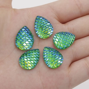 Macro shot of 13x18mm green teardrop resin cabochons with iridescent fish scale pattern