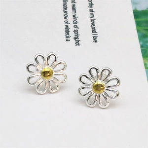 Detailed close-up of daisy stud earrings with silver hollow petals and golden center