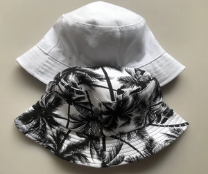 Reversible coconut tree print bucket hat for men and women shown in white and floral patterns