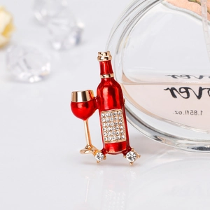 Detailed view of enamel wine bottle and glass brooch with sparkling rhinestones