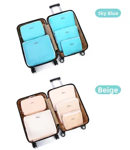 Detailed comparison of sky blue and beige travel storage bags inside a black suitcase