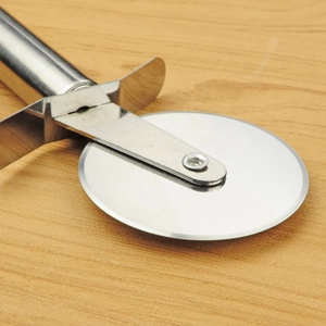 Single wheel pizza cutter made of stainless steel displayed on a wooden board