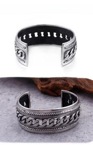 Detailed macro view of vintage punk titanium steel cuff featuring chain relief pattern