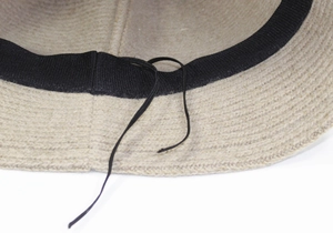 Dettaglio cappello pescatore beige in maglia con fascia interna regolabile e cordino nero