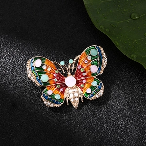 Vintage butterfly brooch with colorful enamel and sparkling crystals on black leather