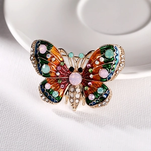 Detailed macro view of vintage butterfly brooch with colorful enamel and inlaid rhinestones