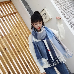 Detailed texture of blue plaid cashmere scarf with soft fringes and knitting pattern