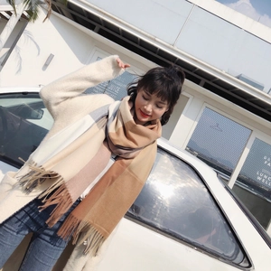 Plaid cashmere-like scarf with tassels styled with a plush knit cardigan for winter