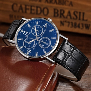 Close-up of luxury navy blue dial watch with black crocodile leather strap on vintage stand