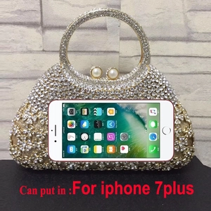 Detail view of champagne gold rhinestone clutch showing capacity for an iPhone 7 Plus