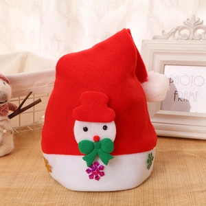 Macro detail of red felt Christmas hat featuring a 3D snowman motif and glitter snowflakes