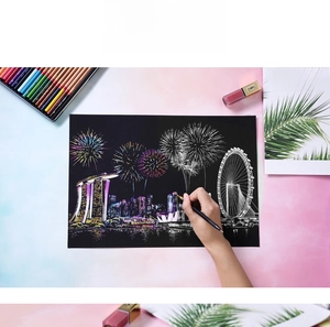 Detail of DIY city scratch art kit showing Singapore skyline with a gold pen