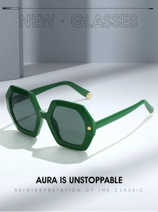Detail of dark green hexagonal sunglasses with silver frames and gold metal rivets