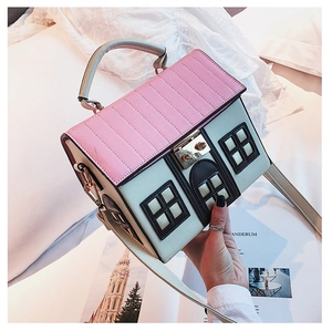 Detailed close-up of a house-shaped crossbody bag with pink quilted roof and cream body
