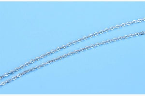 Detailed macro view of high-polished silver link chain on a blue background