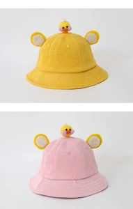 Detail of yellow and pink corduroy bucket hats with cute 3D duck and round ears