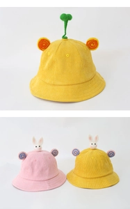 Detail view of yellow and pink corduroy bucket hats with cute rabbit and sprout 3D decor
