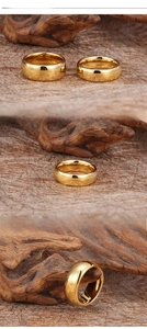 Detailed view of polished gold tungsten steel rings in various widths on natural wood background