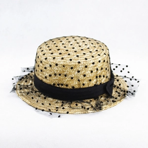 Close-up of boater hat with black polka dots, ribbon bow, and vintage mesh veil detail