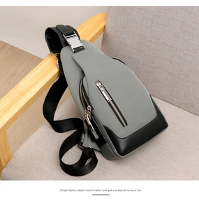 Detail of grey oxford fabric and black leather chest bag with durable silver zippers