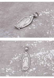 Macro detail of silver titanium steel religious pendant featuring the Virgin Mary