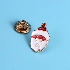 Close-up of Santa Claus enamel brooch with red rhinestone and gold-plated butterfly clutch