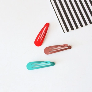 Three colorful candy-colored teardrop BB hair clips in red, brown, and turquoise metal