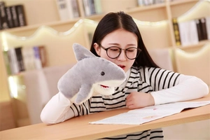 Detail of plush shark hand puppet with soft fabric and realistic teeth for storytelling