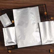 Detailed view of silver aluminum foil stand-up pouches in four different sizes for food storage