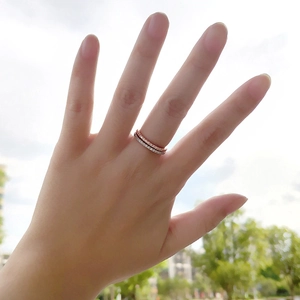 Minimalist stackable cubic zirconia rings in rose gold and silver finishes on hand