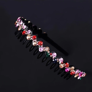 Close-up of wave-shaped headband with colorful rhinestones on a black background