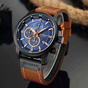 Macro detail of Curren chronograph watch featuring blue dial and brown leather strap