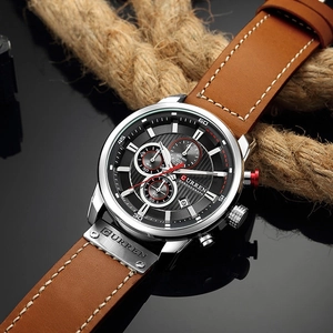 Macro detail of Curren men's watch featuring a black textured dial and brown leather strap