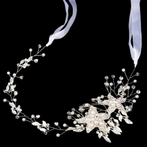 Detailed close-up of handmade bridal hair vine with pearls, crystals, and silver leaves