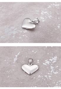 Close-up of polished silver heart-shaped stainless steel pendant from multiple angles