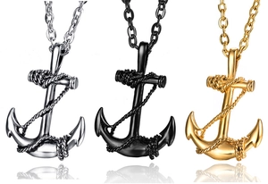 Detailed view of anchor pendants in silver, black, and gold stainless steel on white