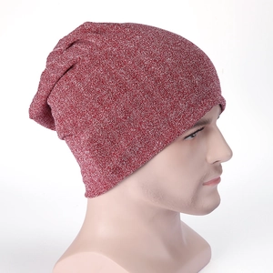 Close-up of red knit beanie showing dual-tone texture and subtle sparkling silver threads