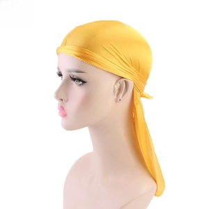 Detail view of bright yellow silky durag with long tail and premium satin texture