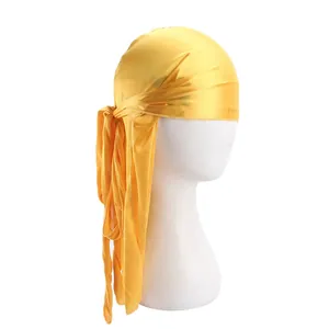 Detail of bright yellow silky satin durag with long straps and shiny smooth finish