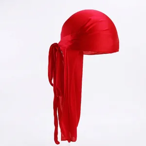 Detail view of the red silky satin durag with long ties and smooth texture