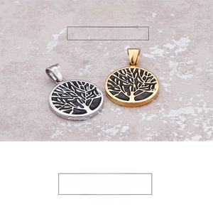 Detailed view of silver and gold tree of life pendants with black enamel filling