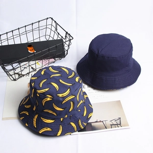 Reversible navy blue canvas bucket hats with solid color and cartoon banana patterns