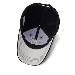 Detail view of the baseball cap's inner structure with embroidery and adjustable metal buckle
