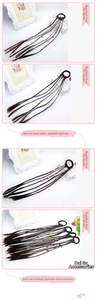 Detail of synthetic hair extensions with colorful beads on a black elastic hair tie