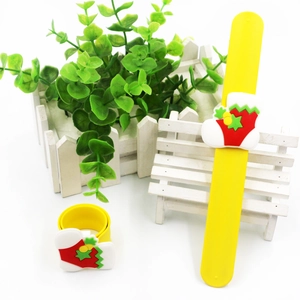 Christmas silicone slap bracelet with holiday stocking design on white bench detail